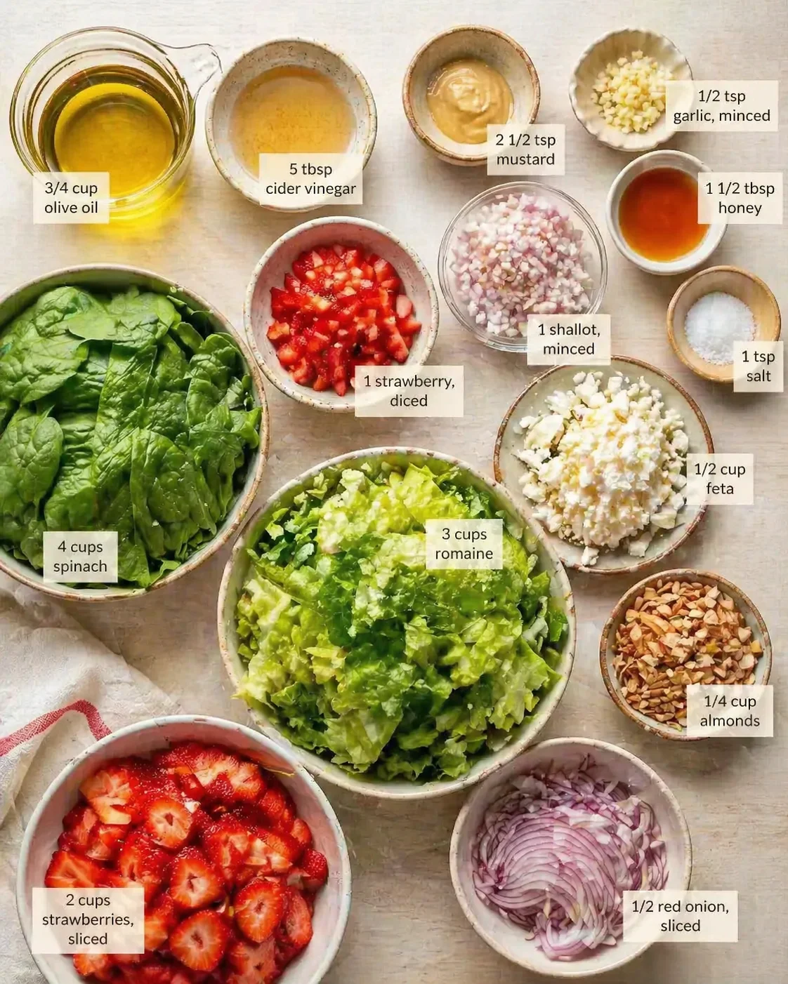 Measured ingredients arranged for Simple Strawberry Romaine Feta Salad: 3/4 cup olive oil, 5 tbsp cider vinegar, 2 1/2 tsp mustard, 1/2 tsp garlic, minced, 1 1/2 tbsp honey, 1 tsp salt