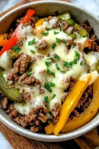 Philly Cheesesteak Bowls Easy Low Carb Dinner with tender beef, peppers, onions, and melted provolone cheese over cauliflower rice