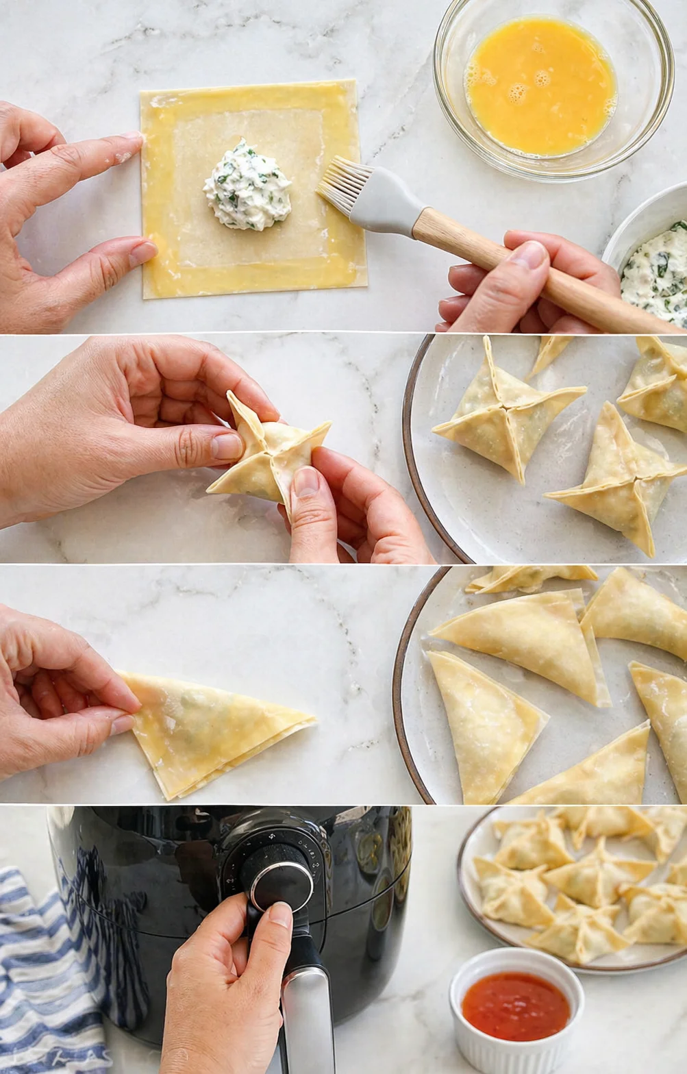 Hands shaping pastry squares with herb cheese filling into triangles on a marble counter, with egg wash nearby.