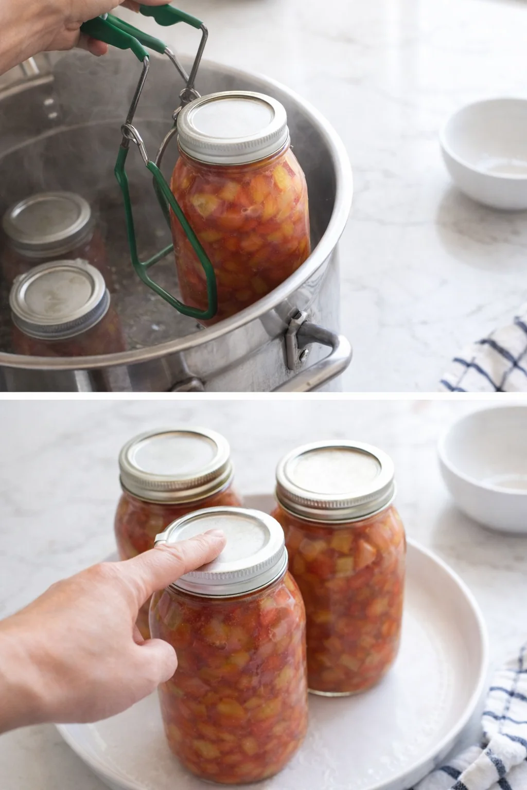 Hand uses green jar lifter to lift a fruit-filled jar from a metal canner.
