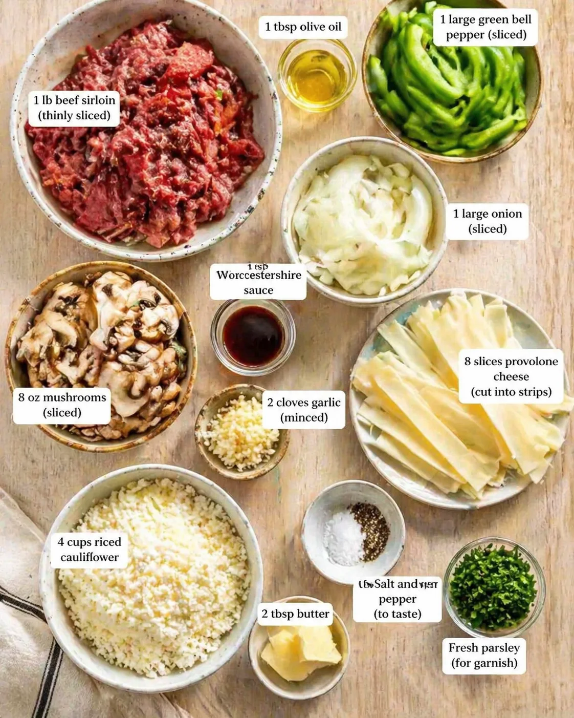 Overhead shot of labeled lasagna ingredients in bowls on a wooden table.