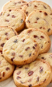 Close-up of freshly baked slice and bake cookies with cherries and chocolate chips.