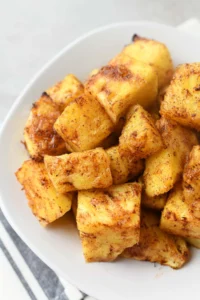 Air Fried Pineapple Chunks in a white dish.