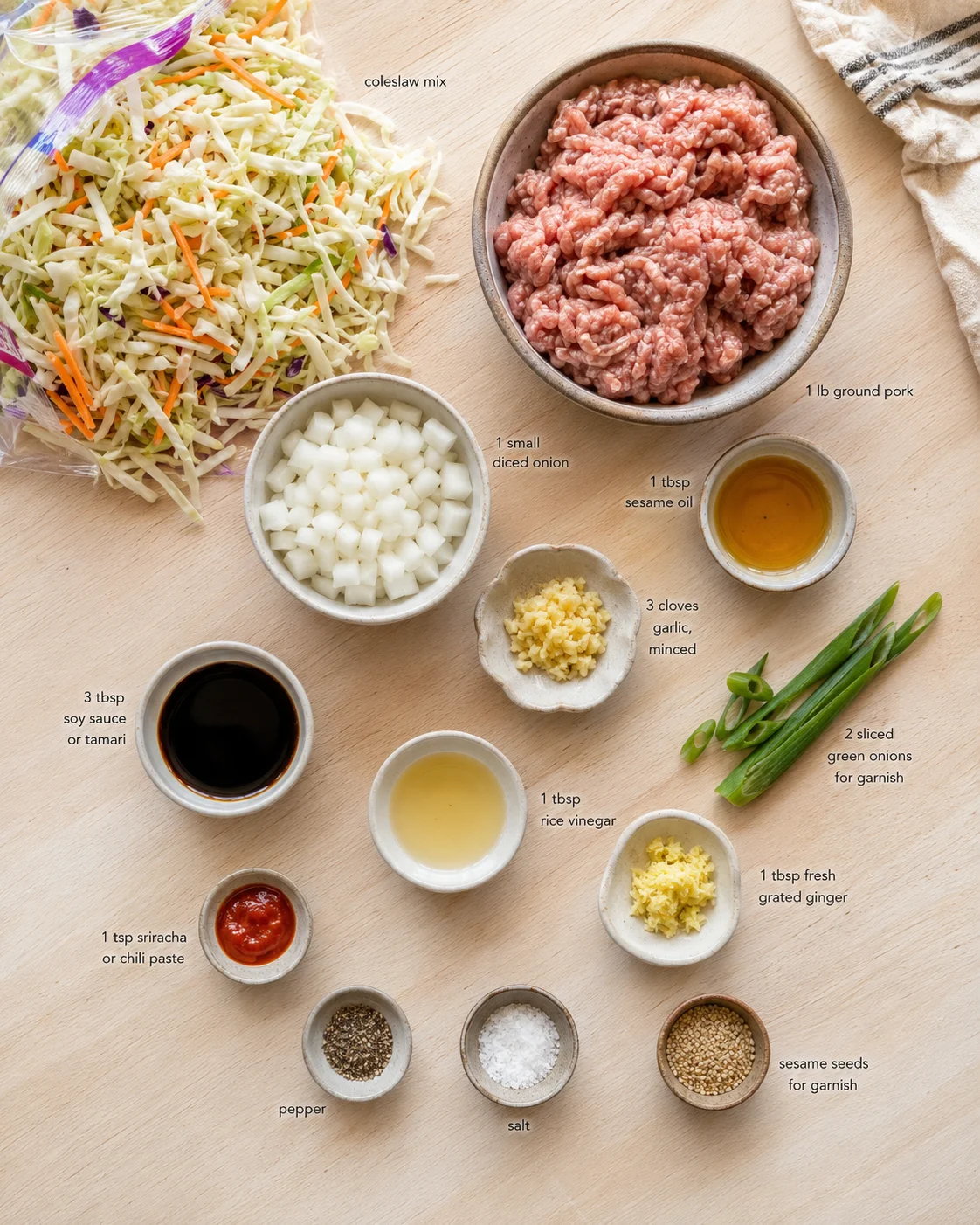 Top-down flat lay of pork-stir-fry ingredients on a wooden surface with labeled bowls.