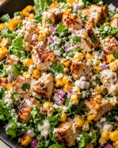 Colorful salad with grilled chicken, corn, and fresh vegetables on a plate