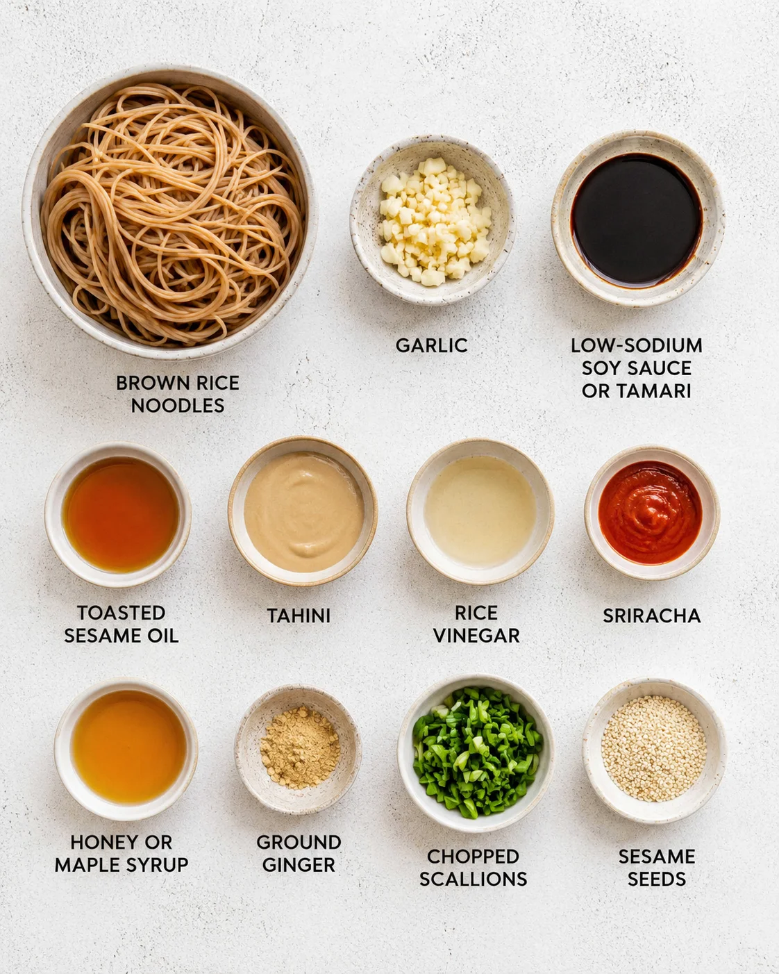 Display of ingredients for garlic sesame noodles including noodles, garlic, sauces, and spices.