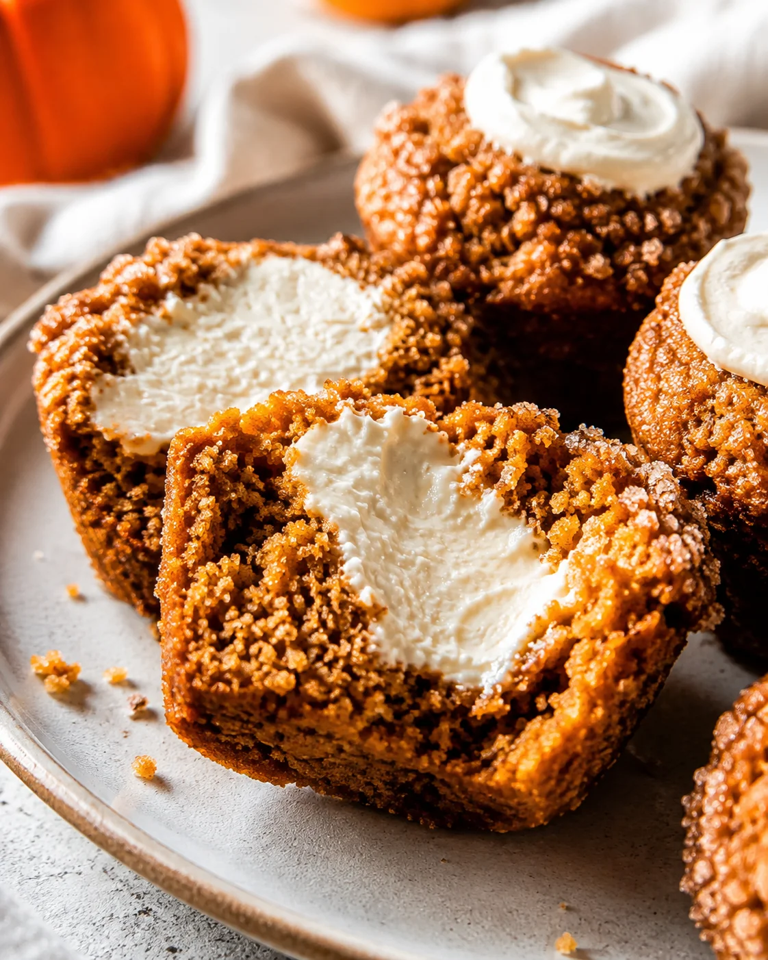 Close-up of hollowed pumpkin muffins filled with fluffy maple cream cheese filling