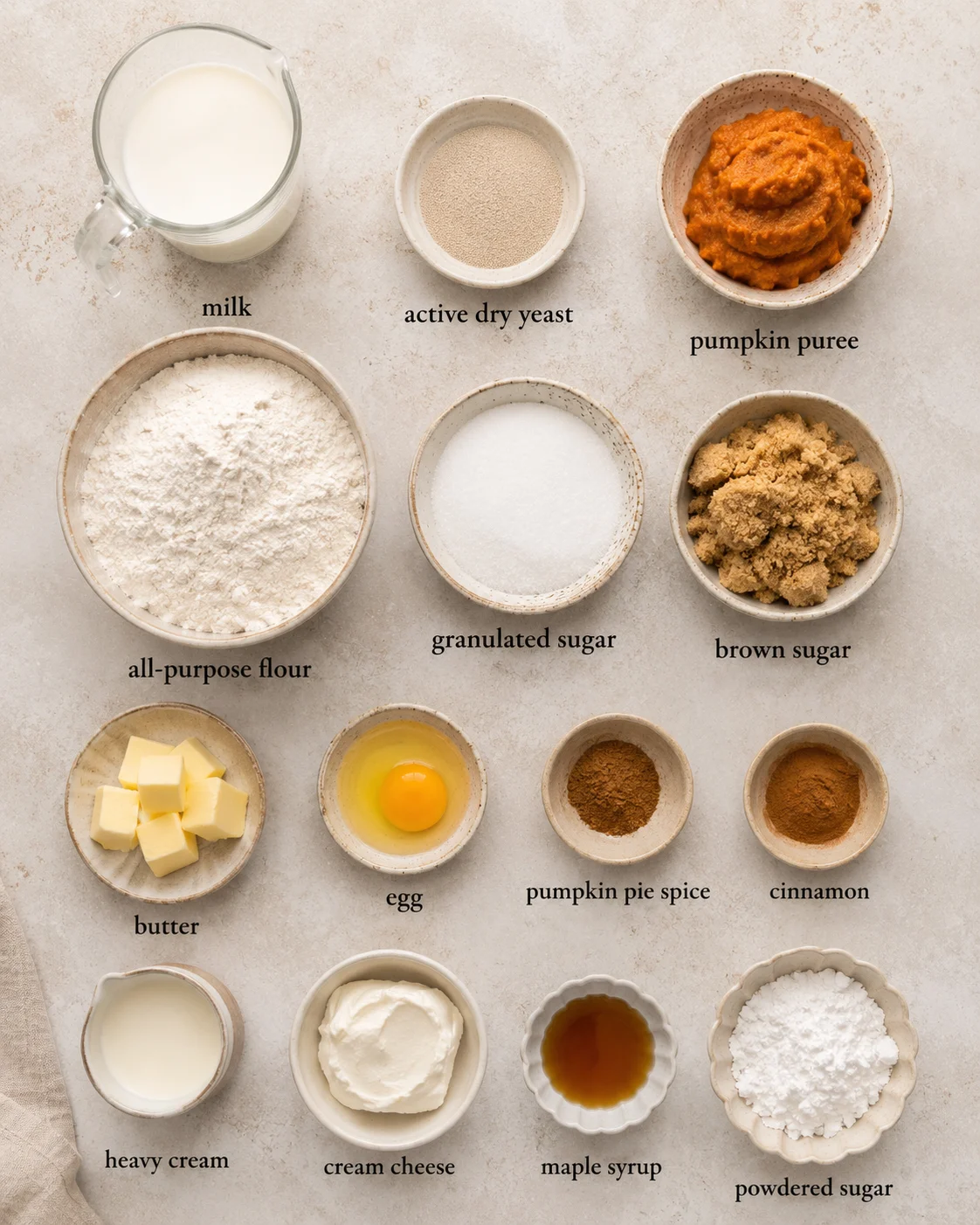 Ingredients including pumpkin puree, flour, and cinnamon for pumpkin cinnamon rolls
