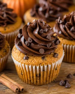 Delicious pumpkin cupcakes topped with rich chocolate frosting and mini chocolate chips.