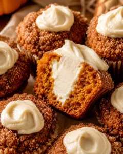 Close-up of delicious pumpkin muffins filled with creamy maple filling and cinnamon sugar topping.