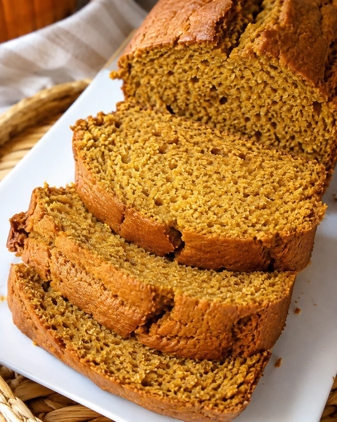 Slice of moist, golden pumpkin bread with vanilla pudding and fall spices.